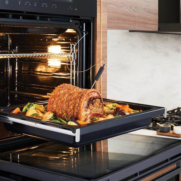 Falcon premium European Glass Black Upright 1100mm Induction Cooker with roast and vegetables in oven tray