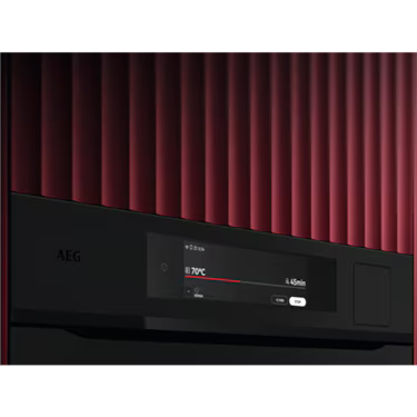 AEG 60cm Steam Oven Matte Black NBP9S83PAT close up on control panel in red textured wall.