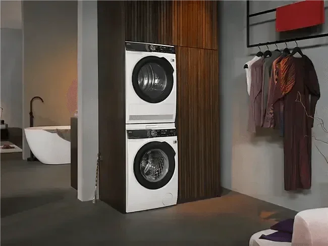 Stacked front-load washer and dryer in modern laundry space with wood paneling