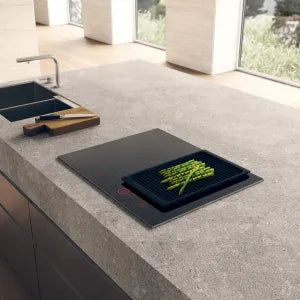 Falcon premium European glass black upright 1100mm induction cooker with asparagus grilling on sleek kitchen countertop