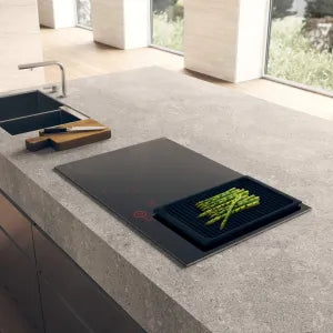 Falcon premium European glass black induction cooker with asparagus on sleek kitchen countertop
