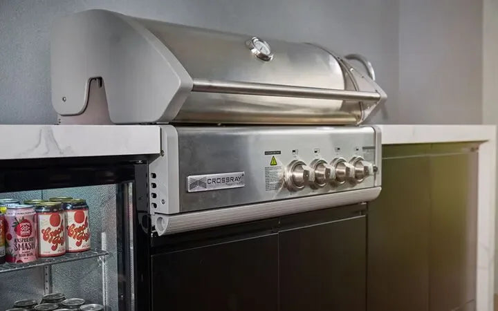 Stainless steel outdoor grill with control knobs and storage below