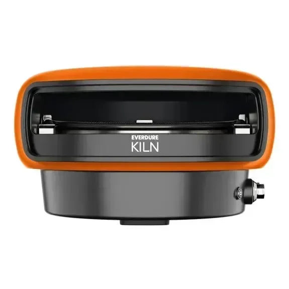 Everdure Kiln outdoor grill with bold orange frame and black cooking chamber, modern designer appliance