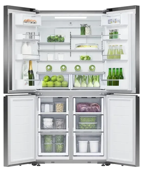 Stainless steel French door refrigerator with open doors, stocked with fresh produce, drinks, and groceries
