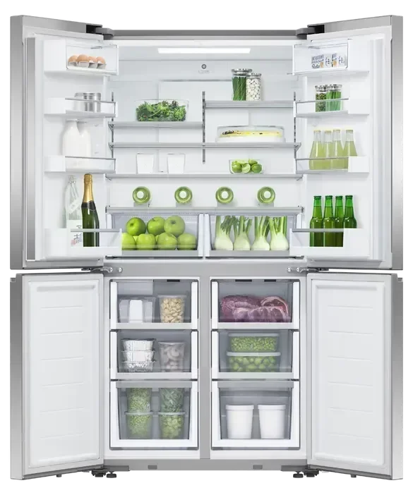 Spacious French door fridge open, filled with drinks, fruits, vegetables, and dairy items.