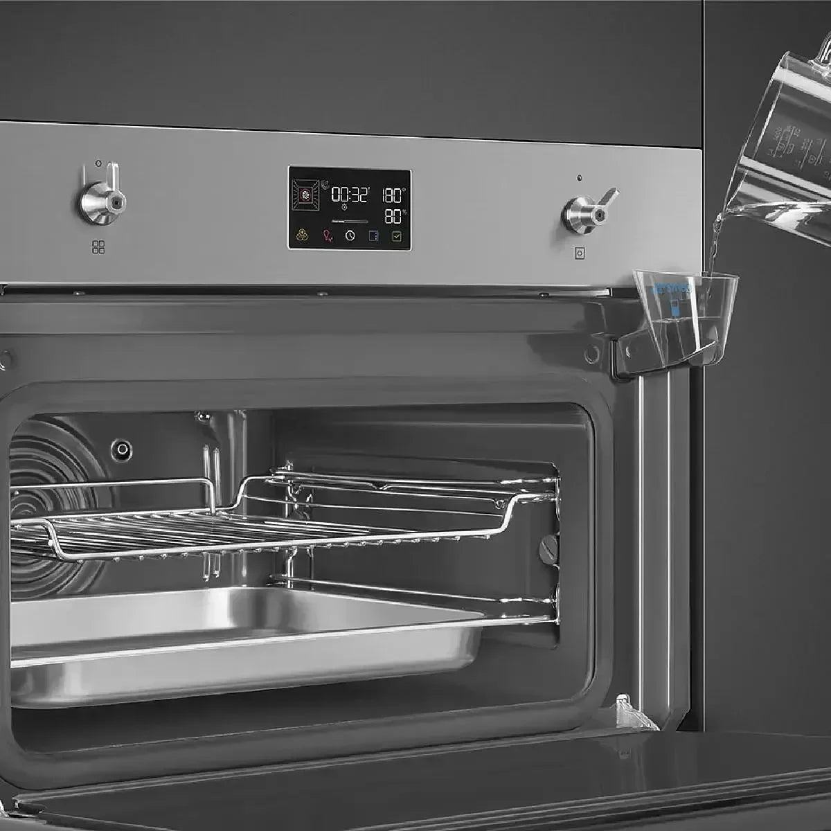 Falcon premium European glass black 1100mm induction cooker with digital display, open oven door and water tray being filled