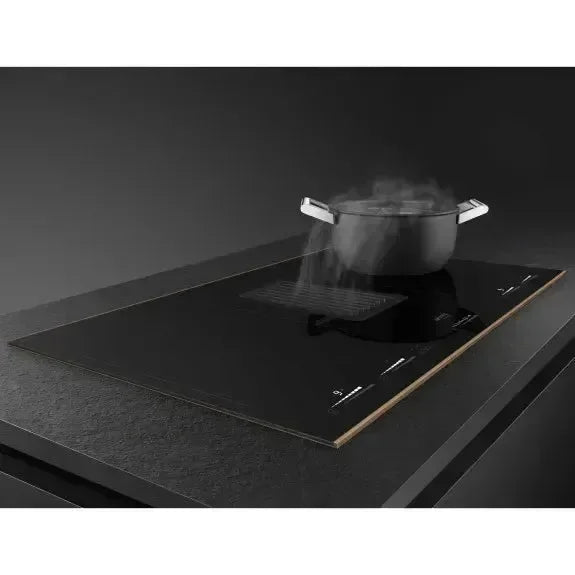 Black induction cooktop with steaming pot, modern kitchen appliance for designer kitchens
