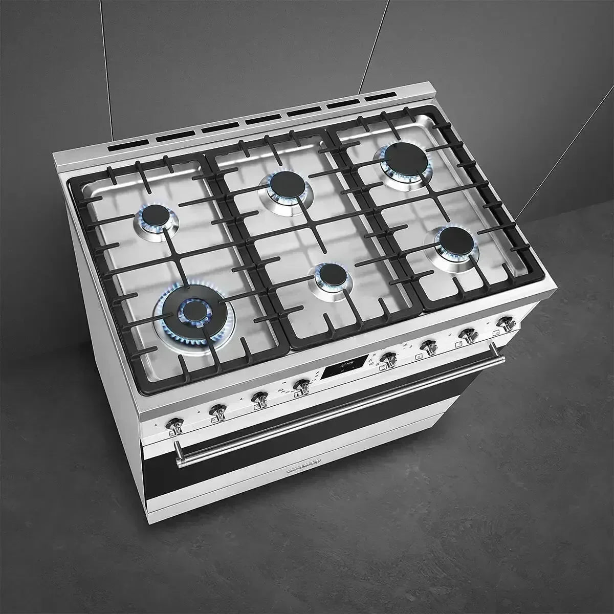 Stainless steel gas range with lit burners, modern kitchen appliance for designer kitchens