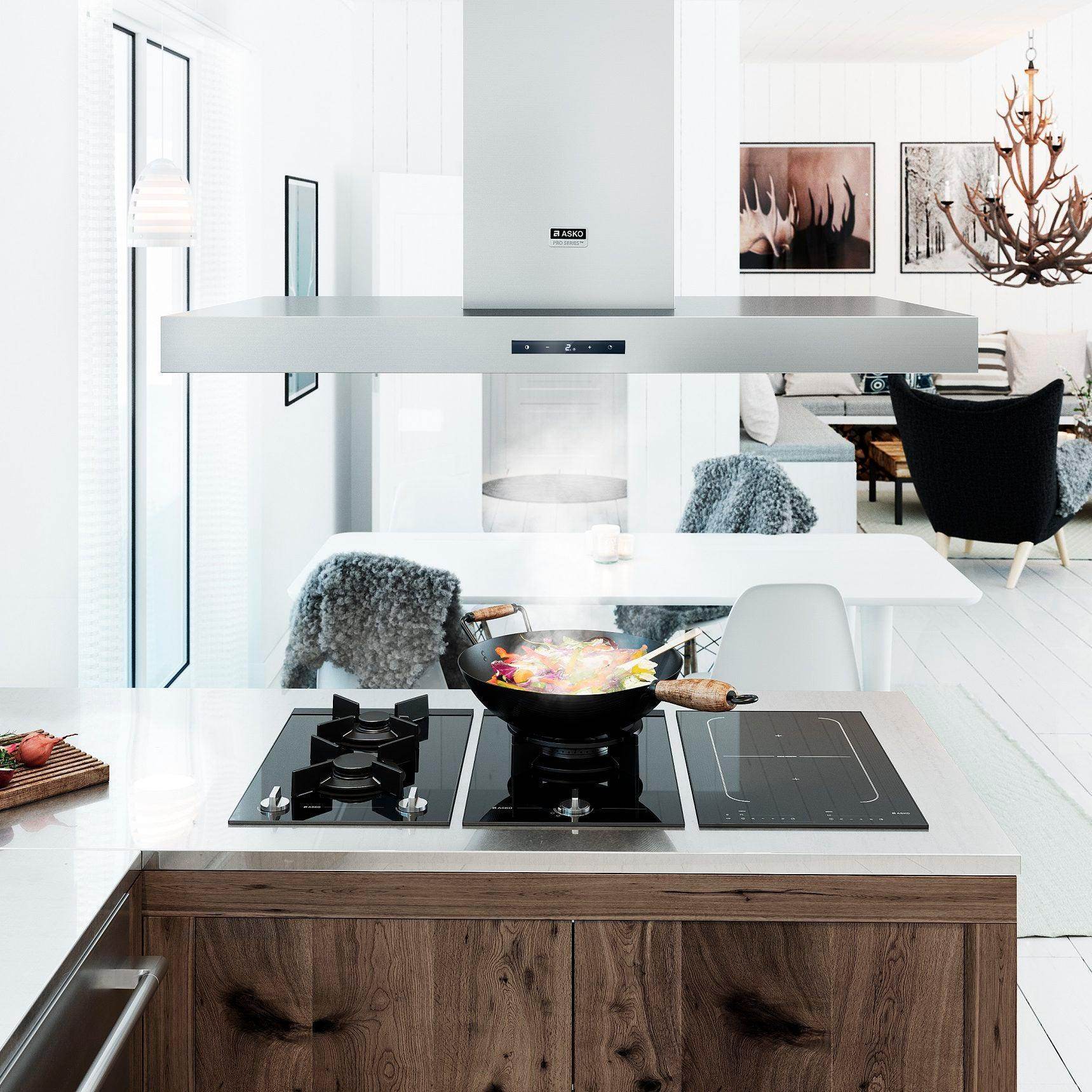 Modern kitchen with ASKO range hood, gas and induction cooktop, wok cooking on island