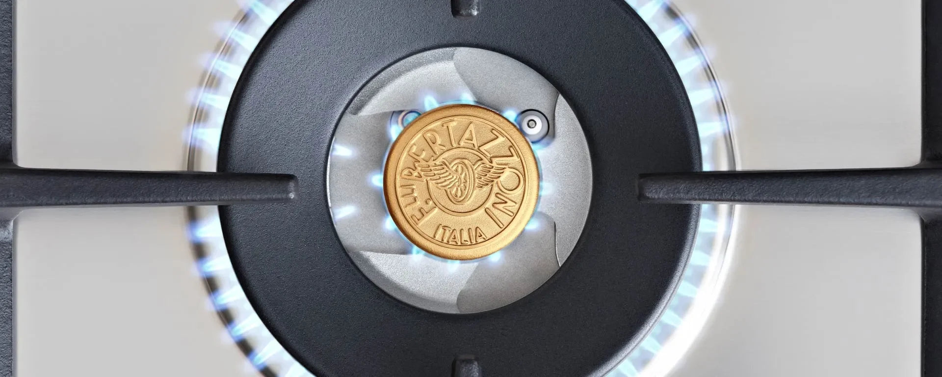 Close-up of a lit Bertazzoni gas stove burner with blue flames and a gold logo center.