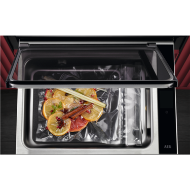 AEG Built-In Vacuum Sealer Drawer NKV914T from above showing citrus slices being sealed into a bag.
