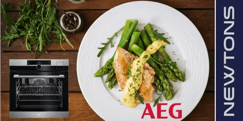 AEG oven with roasted chicken, asparagus, and sauce on white plate, perfect for designer kitchens