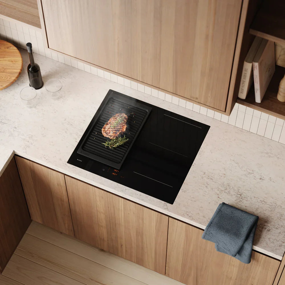 Falcon premium European glass black induction cooker with steak grilling on modern kitchen countertop
