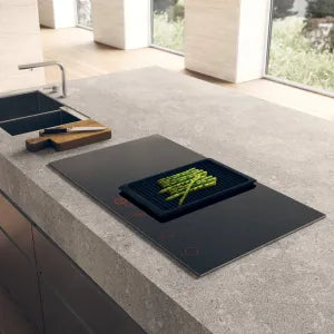 Falcon premium European glass black induction cooker with asparagus on sleek kitchen countertop