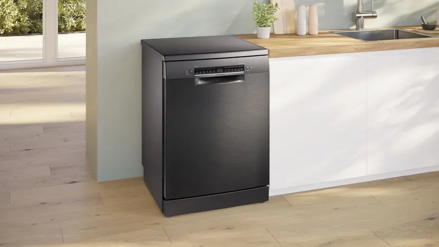 Black upright induction cooker in modern kitchen setting