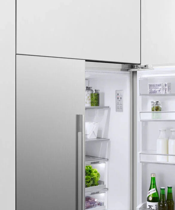 Stainless steel refrigerator with open door displaying fresh produce and beverages inside