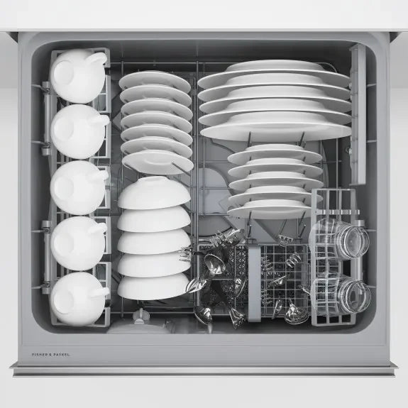 Fisher & Paykel dishwasher interior loaded with clean white dishes, glassware, and utensils, showcasing spacious design