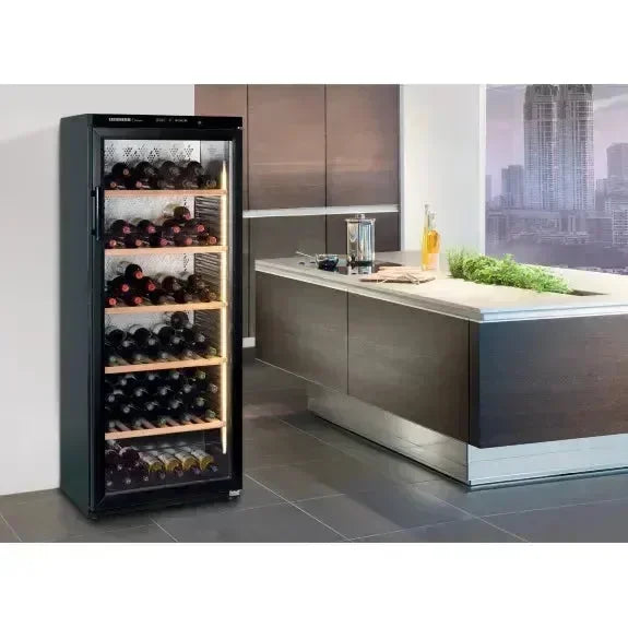 Modern wine cooler with glass door in sleek kitchen, storing bottles on wooden shelves
