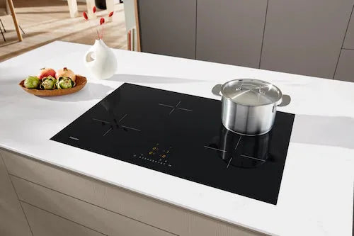 Falcon premium European glass black induction cooker with pot on modern kitchen counter