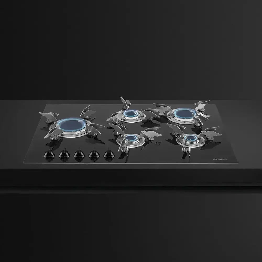 Sleek black glass gas cooktop with five burners and blue flames, modern kitchen appliance