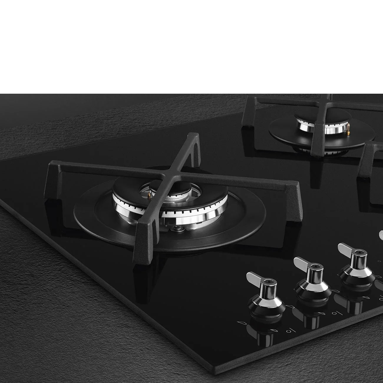 Black glass gas cooktop with stainless steel burners and control knobs