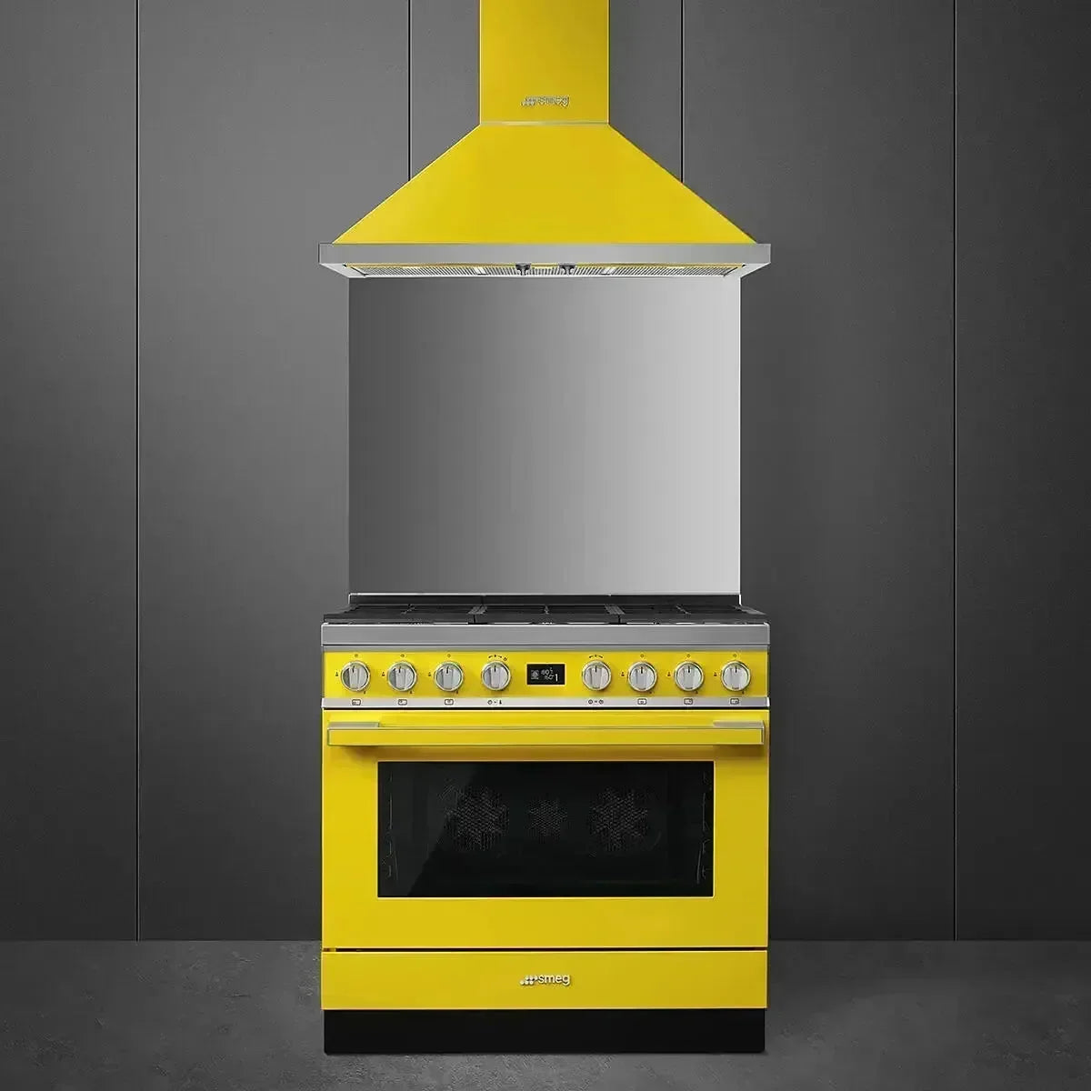 Vibrant yellow Smeg range cooker with matching hood, modern kitchen appliance