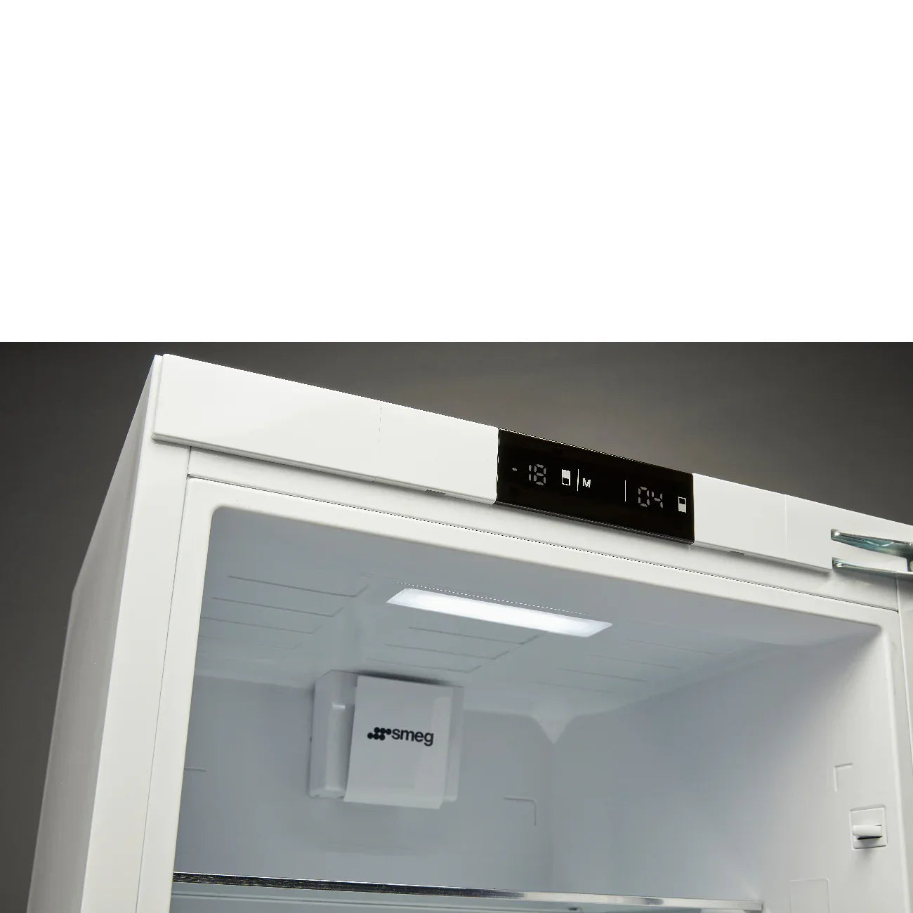 White Smeg upright freezer with digital display, interior light, and temperature controls visible